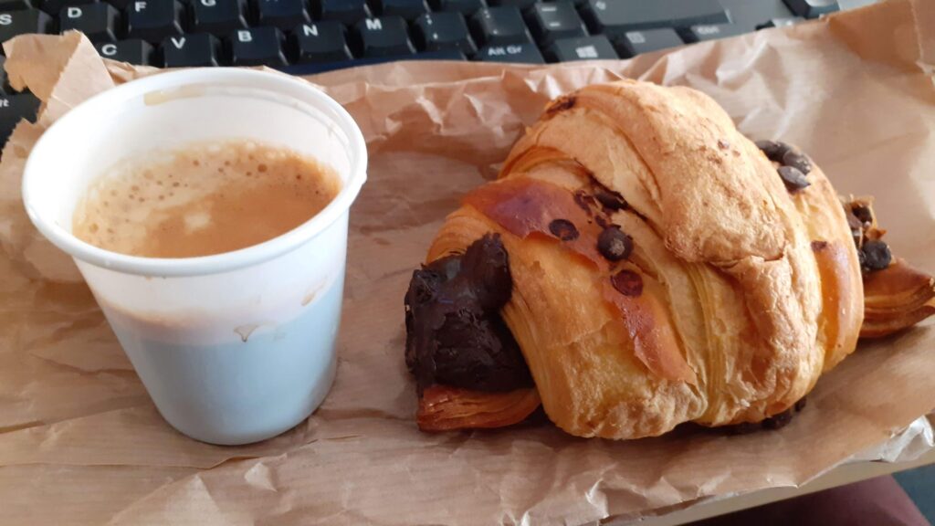 Chocolate croissant with a coffee